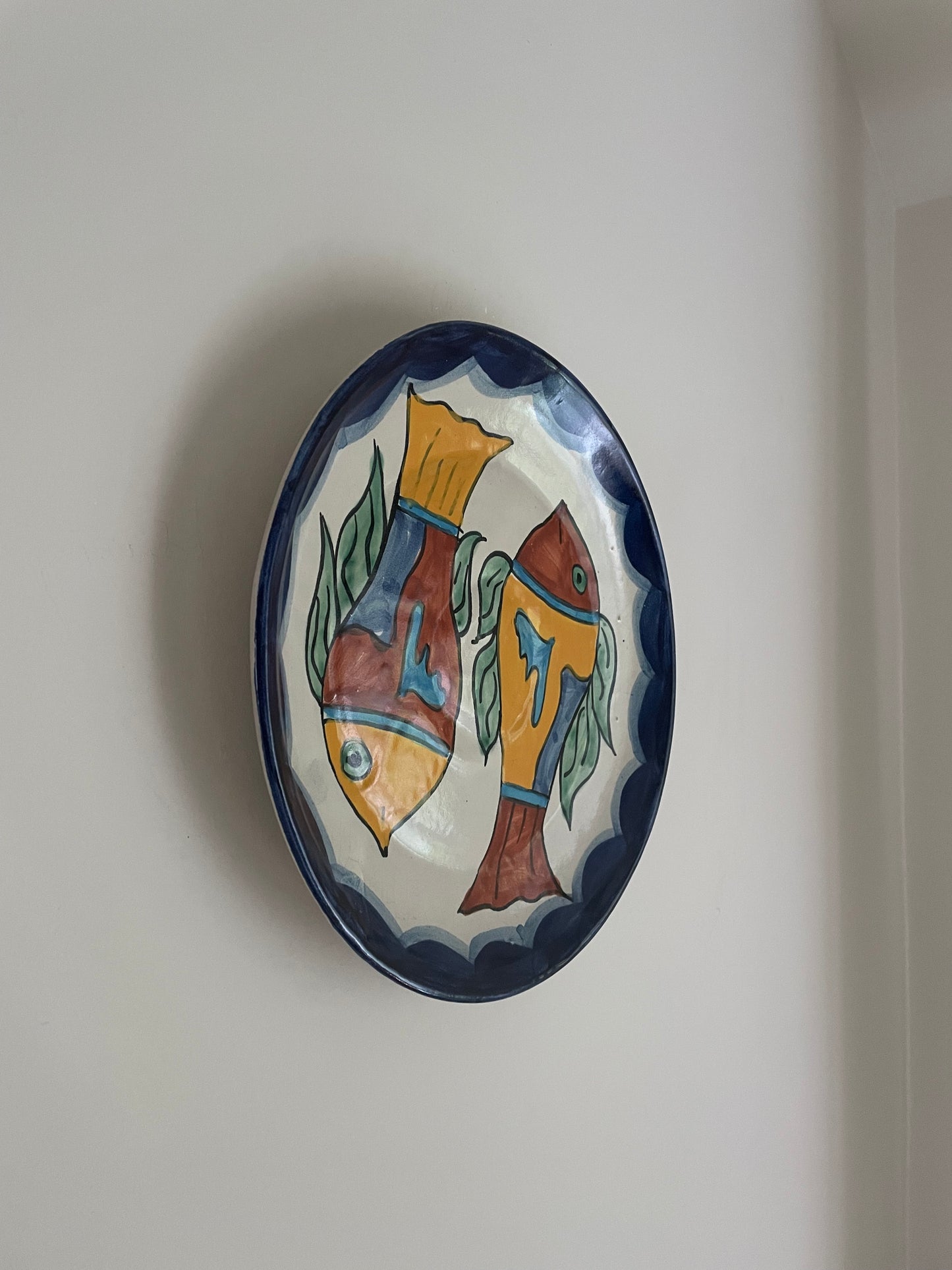 Vintage hand painted Mexican wall plate of colourful fish