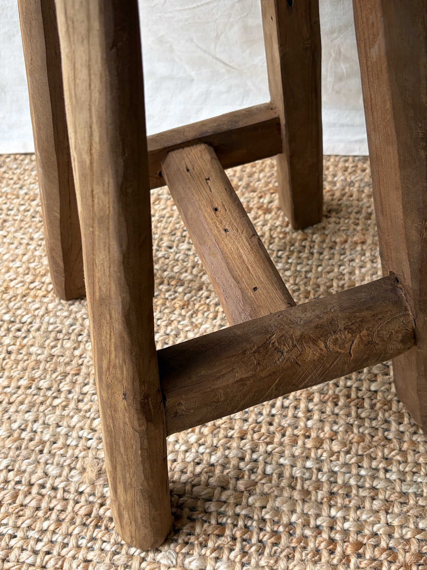 Vintage mid brown four legged wooden stool with round top