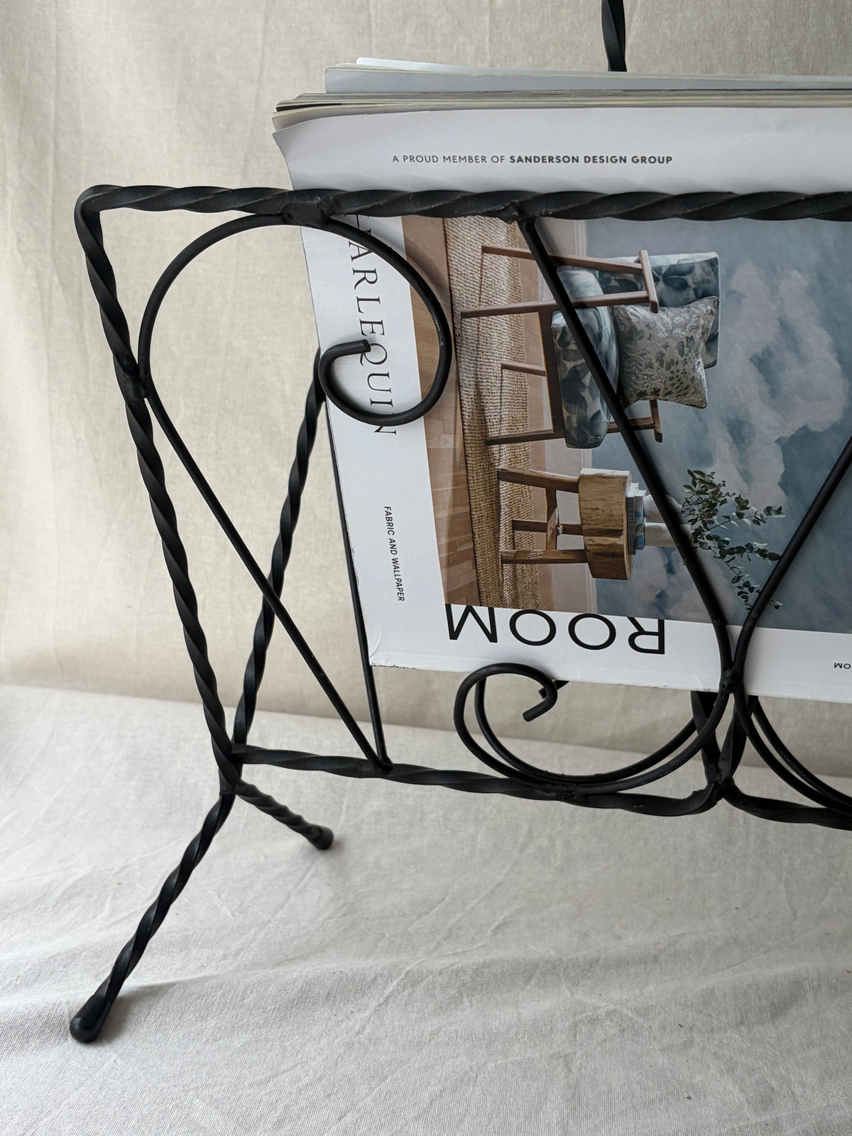 Vintage iron magazine rack with twisted and scroll details