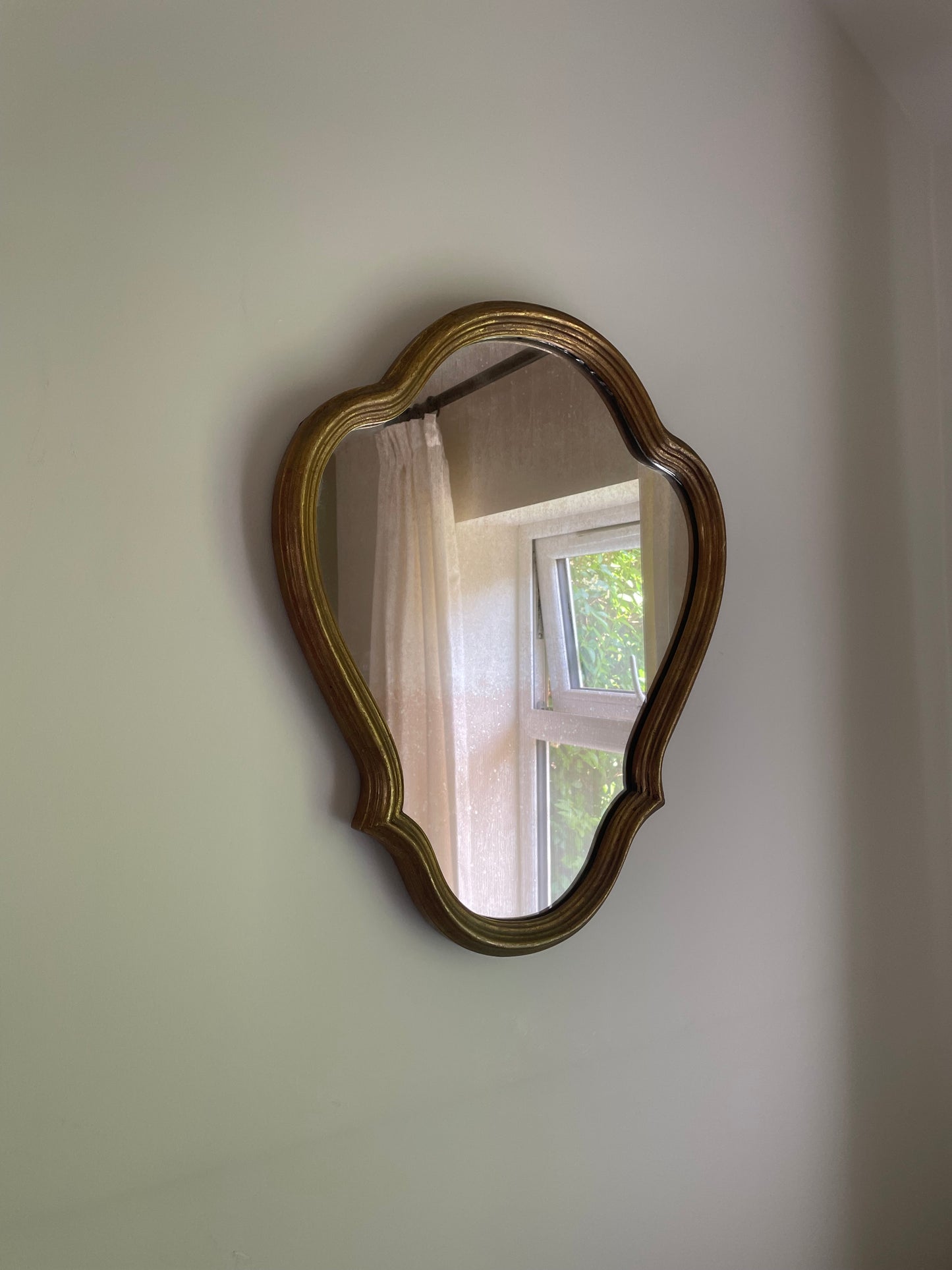 Scalloped wooden gilt wall mirror