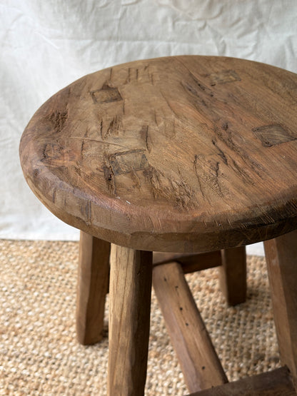 Vintage mid brown four legged wooden stool with round top