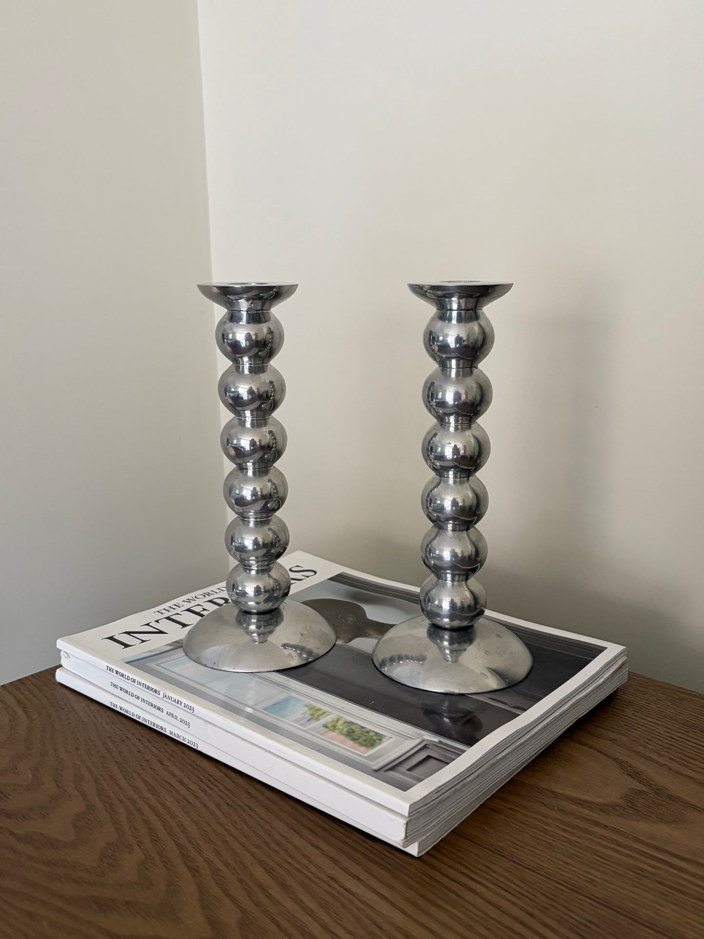 Pair of vintage cast aluminium bobbin candlesticks