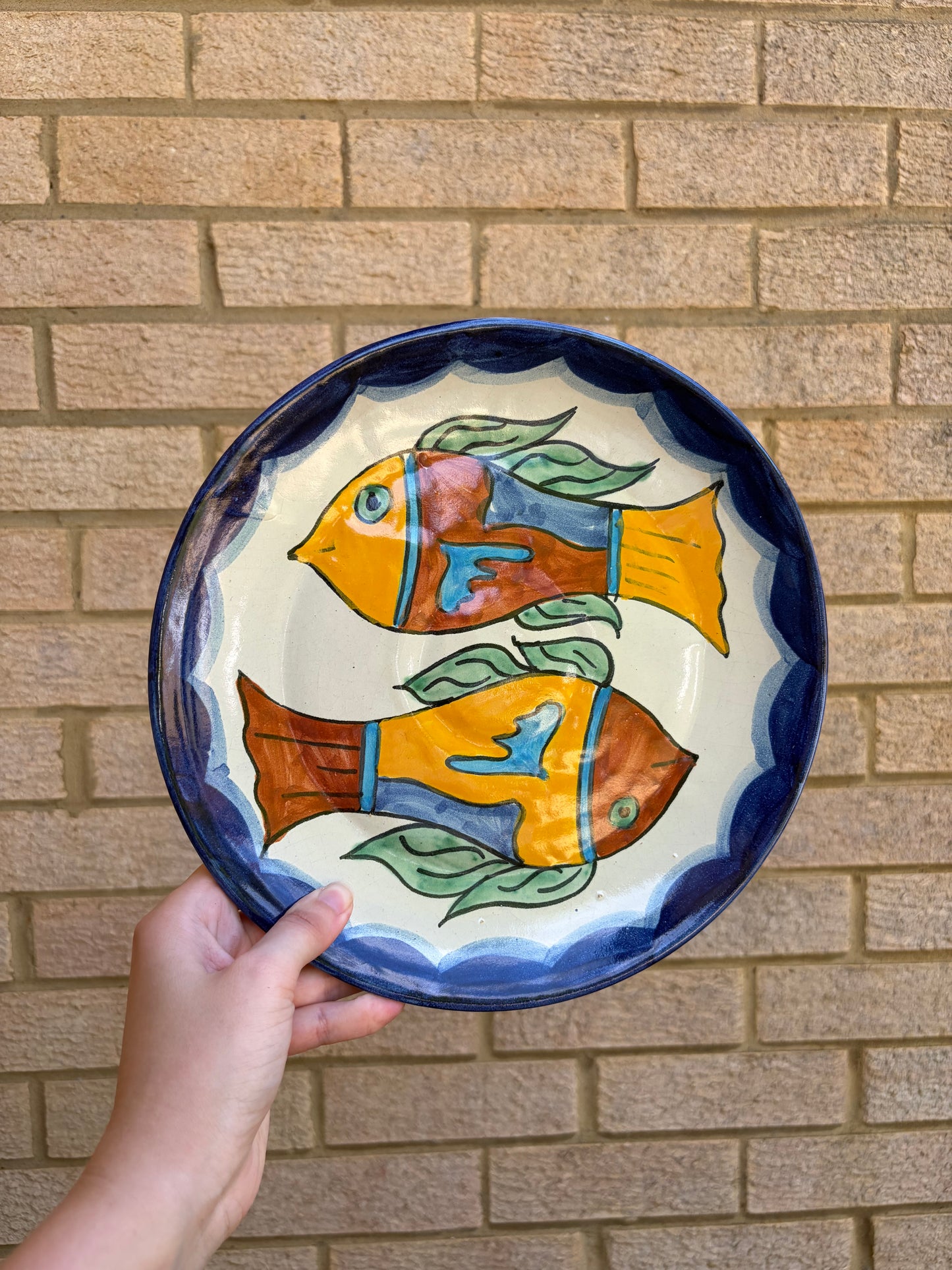 Vintage hand painted Mexican wall plate of colourful fish