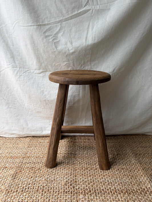 Vintage mid brown four legged wooden stool with round top