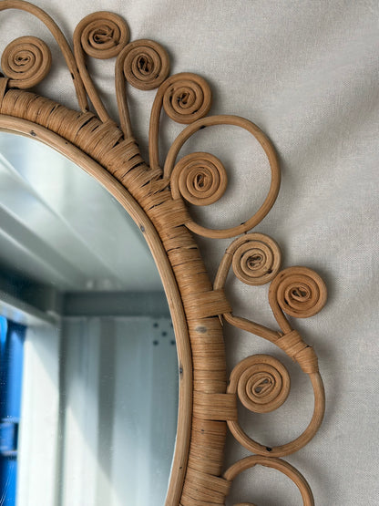 Vintage oval rattan mirror with scrollwork swirls