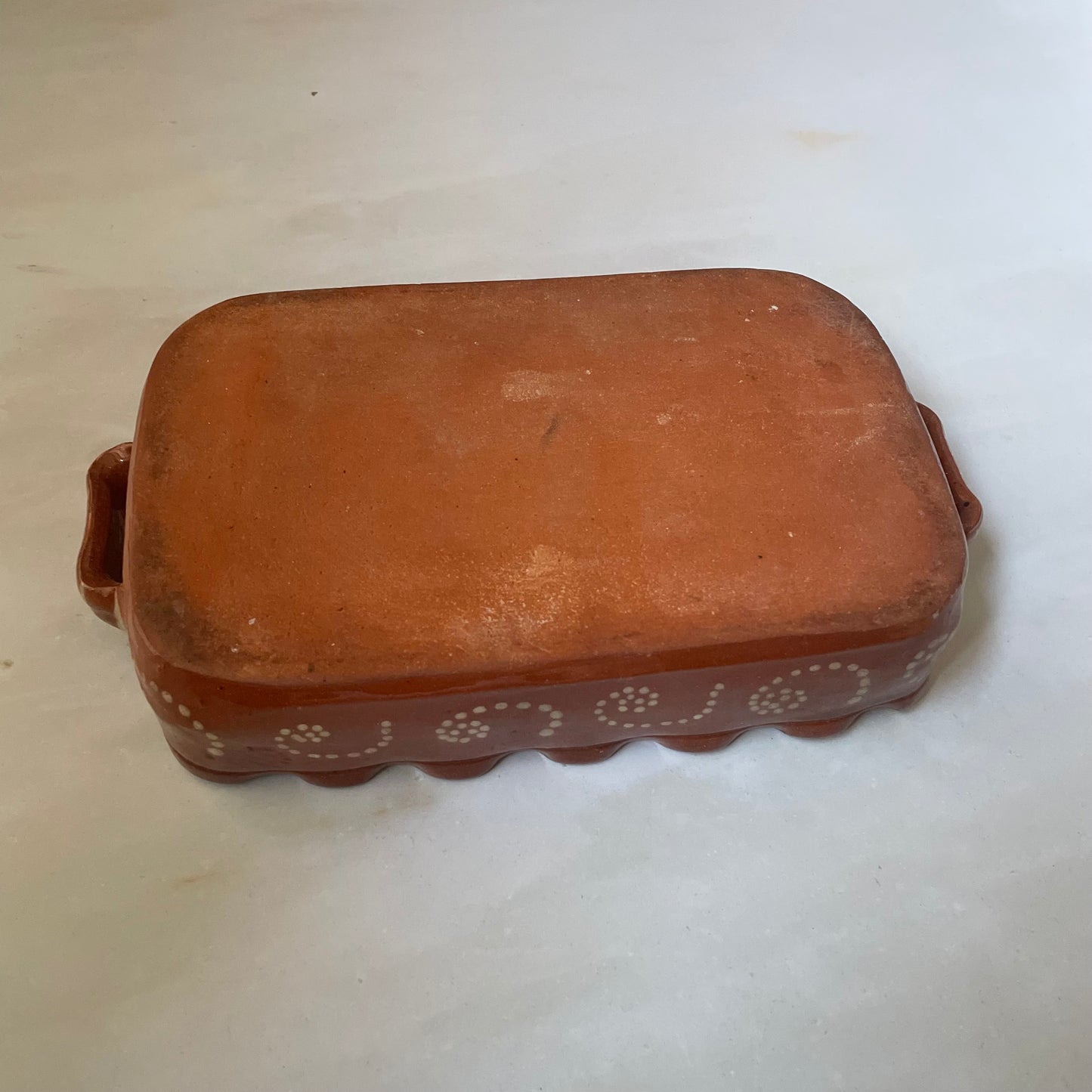 Terracotta dish with fish design