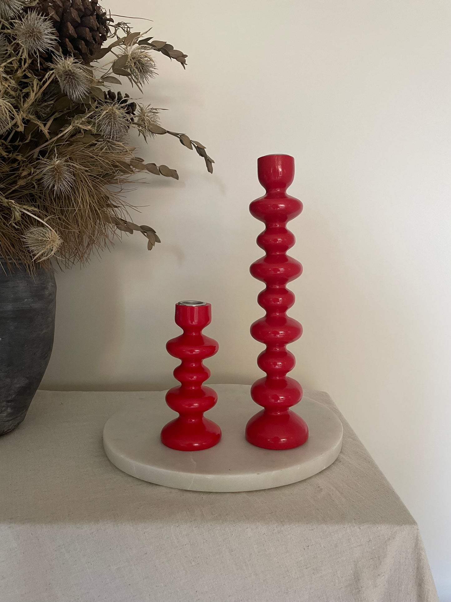 Vintage pair of red wooden bobbin candlestick holders