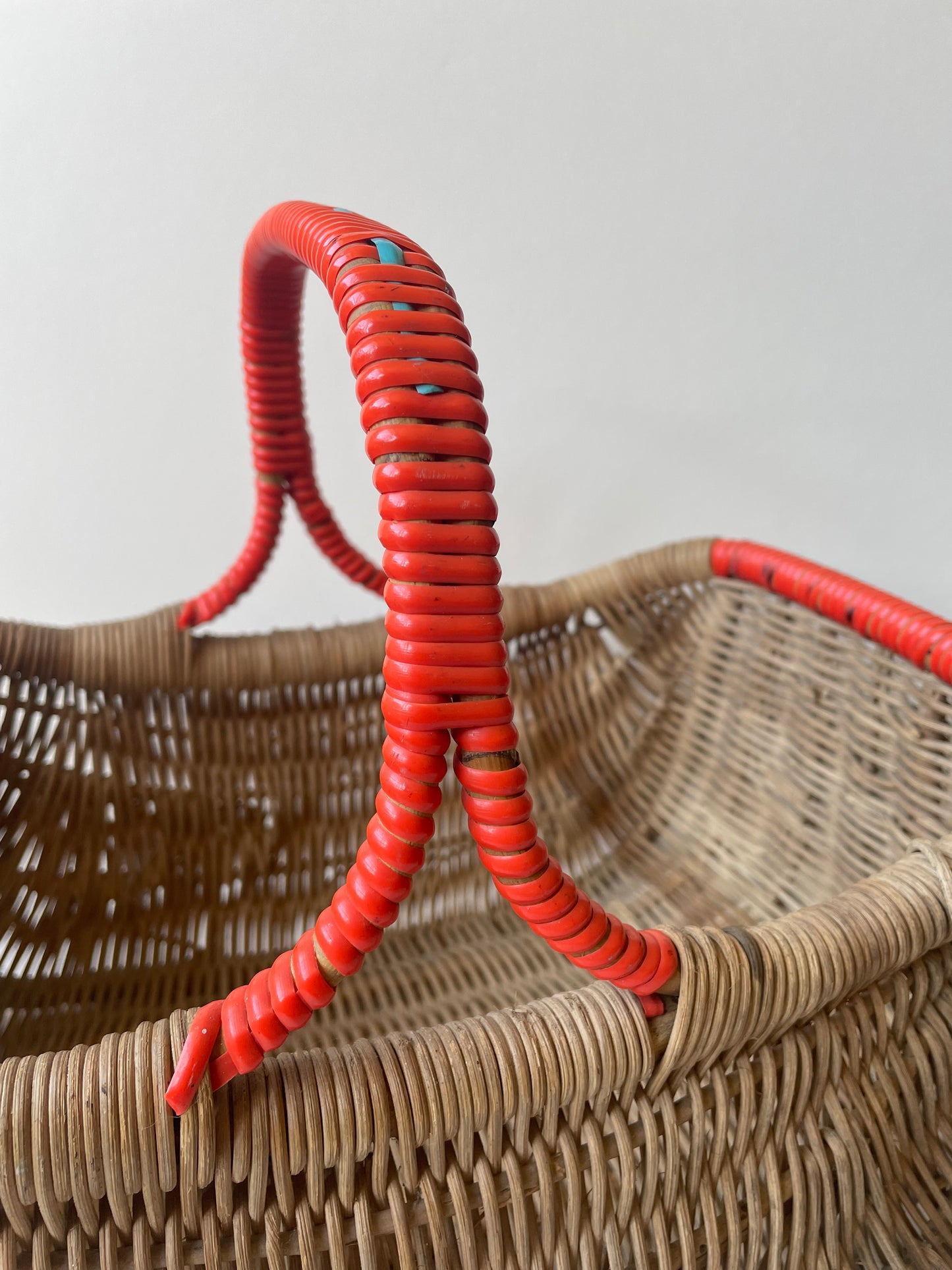 Wicker basket with red contrast handle