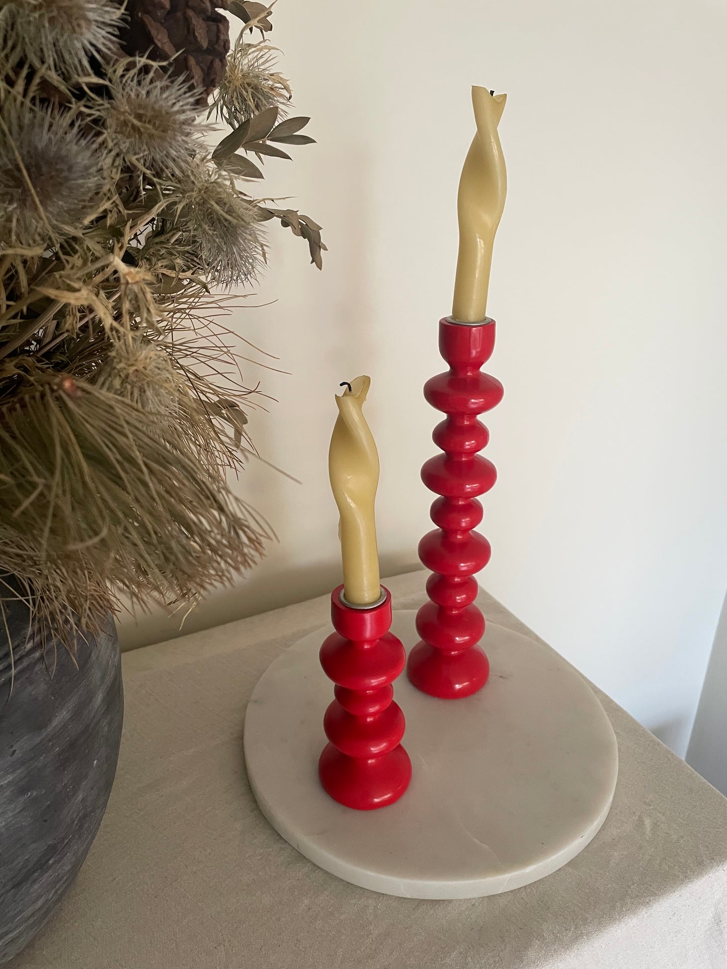 Vintage pair of red wooden bobbin candlestick holders