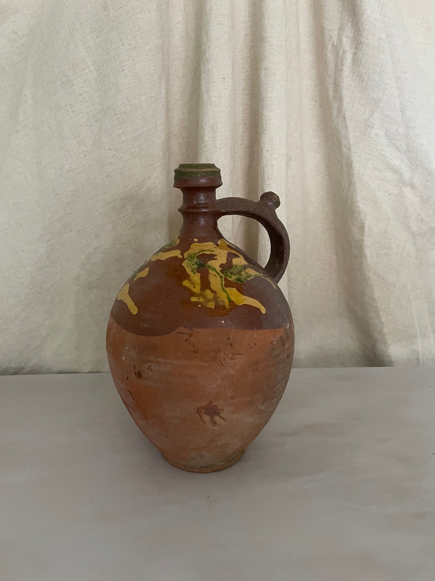 Terracotta jug with yellow