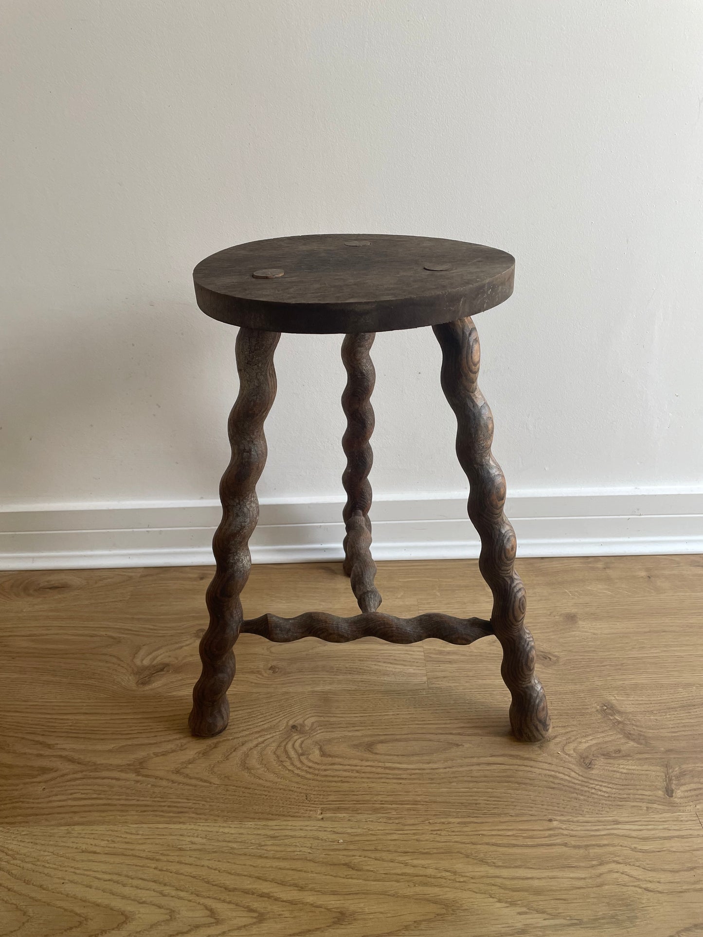Antique French stool with wavy legs and round top