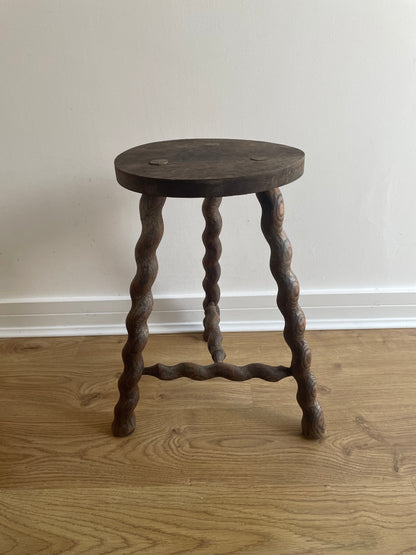 Antique French stool with wavy legs and round top