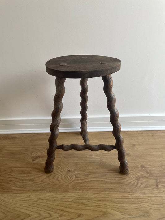 Antique French stool with wavy legs and round top