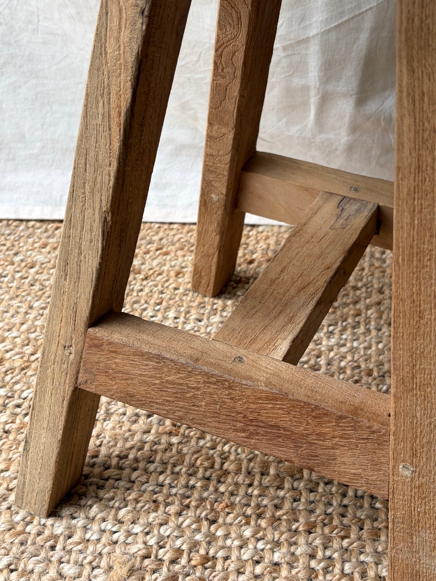 Vintage light wooden four legged stool with round top