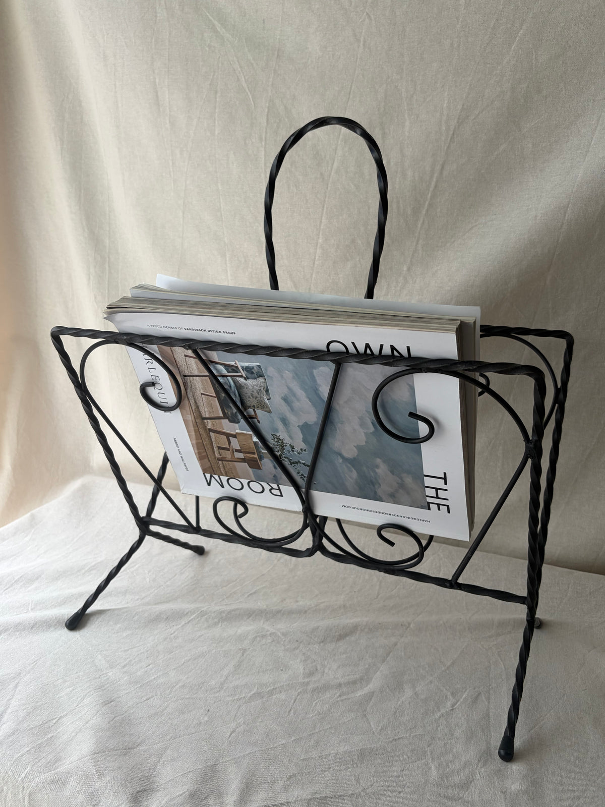 Vintage iron magazine rack with twisted and scroll details