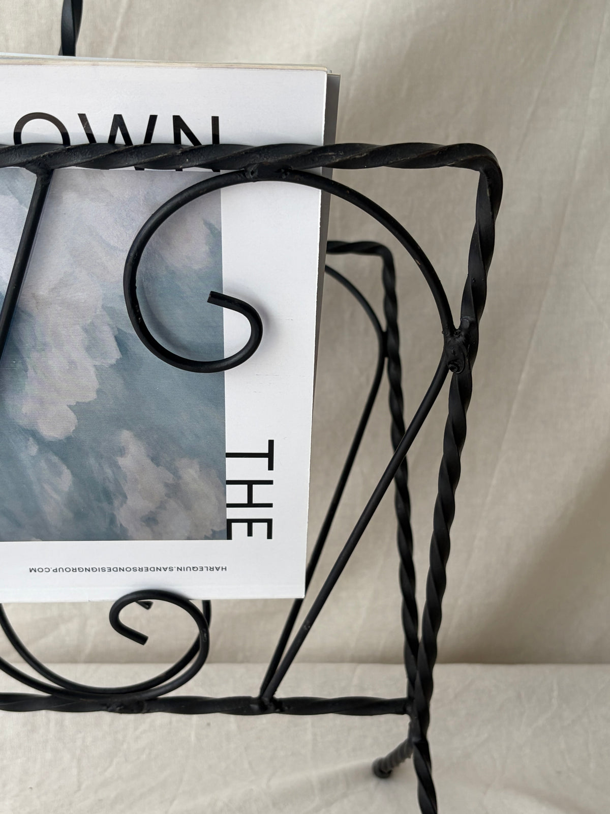 Vintage iron magazine rack with twisted and scroll details
