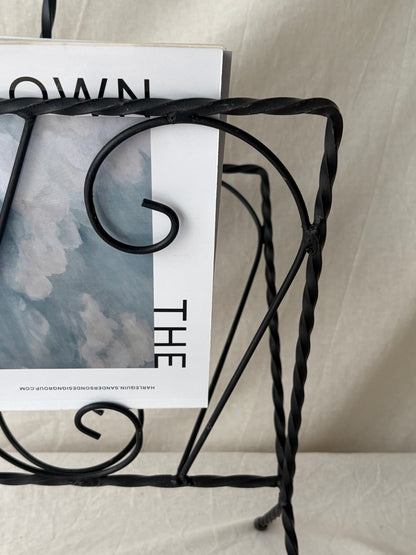 Vintage iron magazine rack with twisted and scroll details
