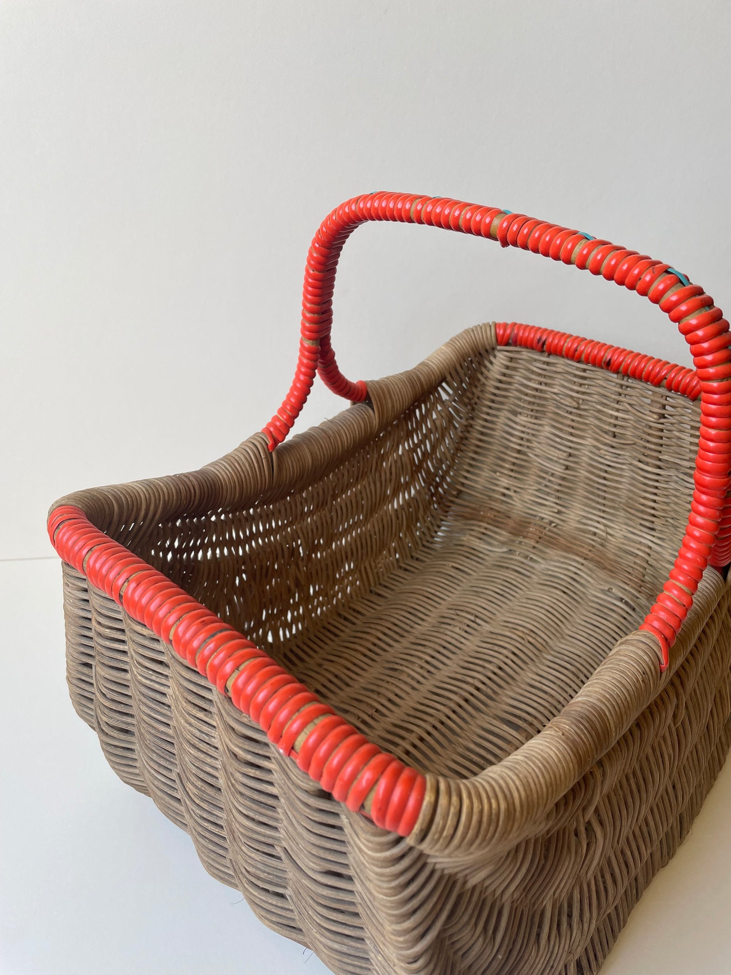 Wicker basket with red contrast handle