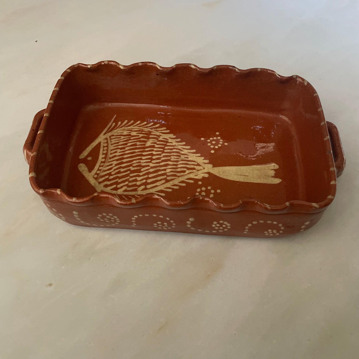 Terracotta dish with fish design