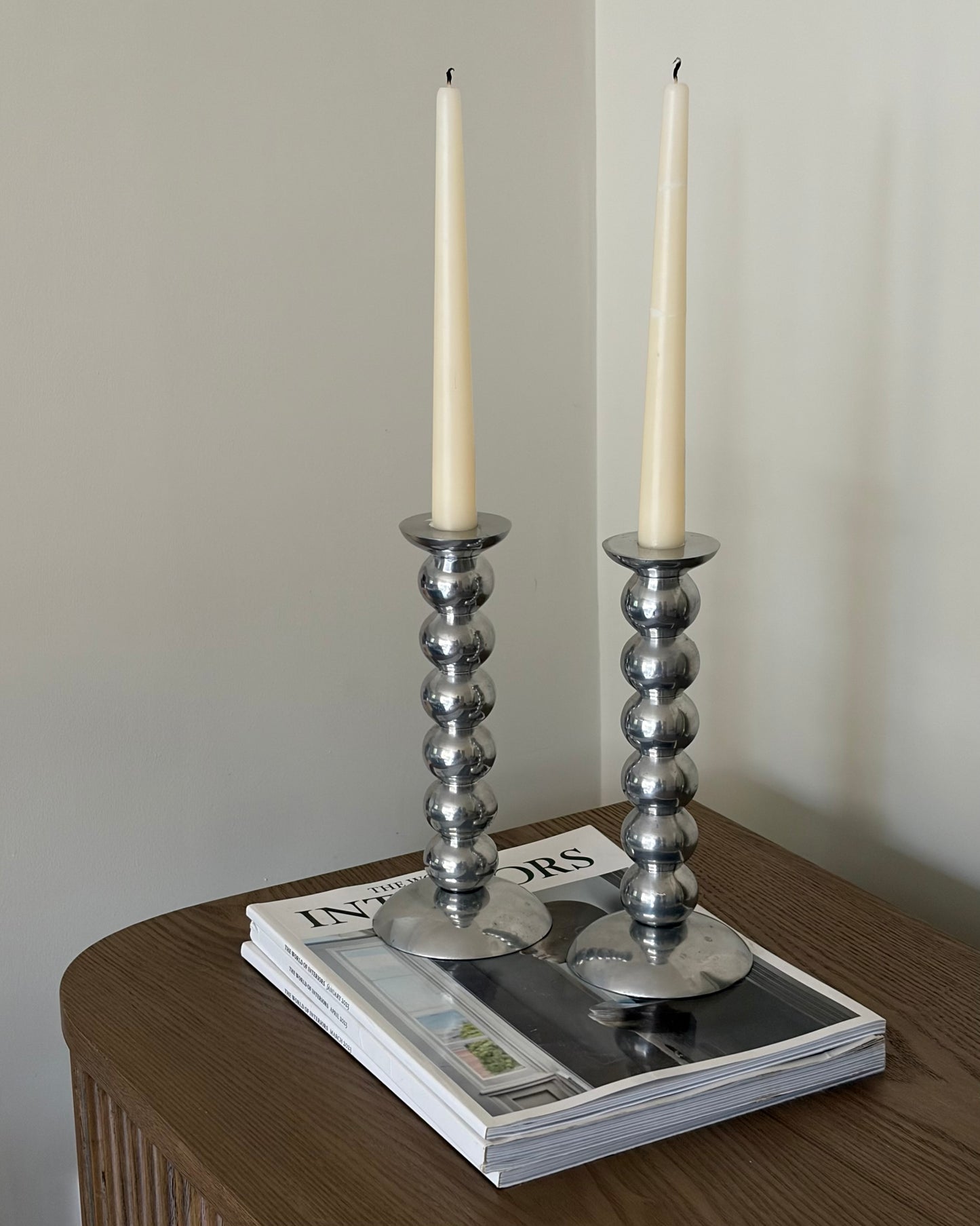 Pair of vintage cast aluminium bobbin candlesticks