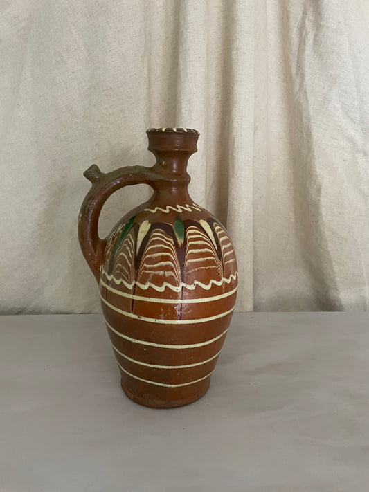 Terracota jug with white lines