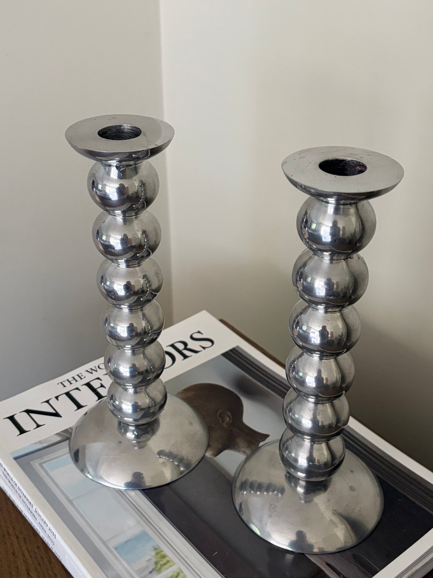 Pair of vintage cast aluminium bobbin candlesticks
