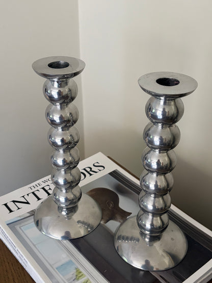 Pair of vintage cast aluminium bobbin candlesticks