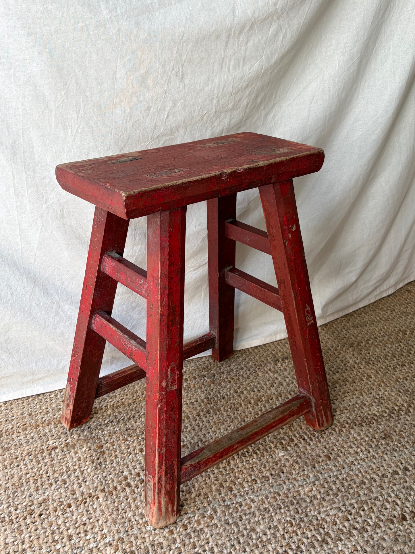 Vintage rustic red chipped wooden stool