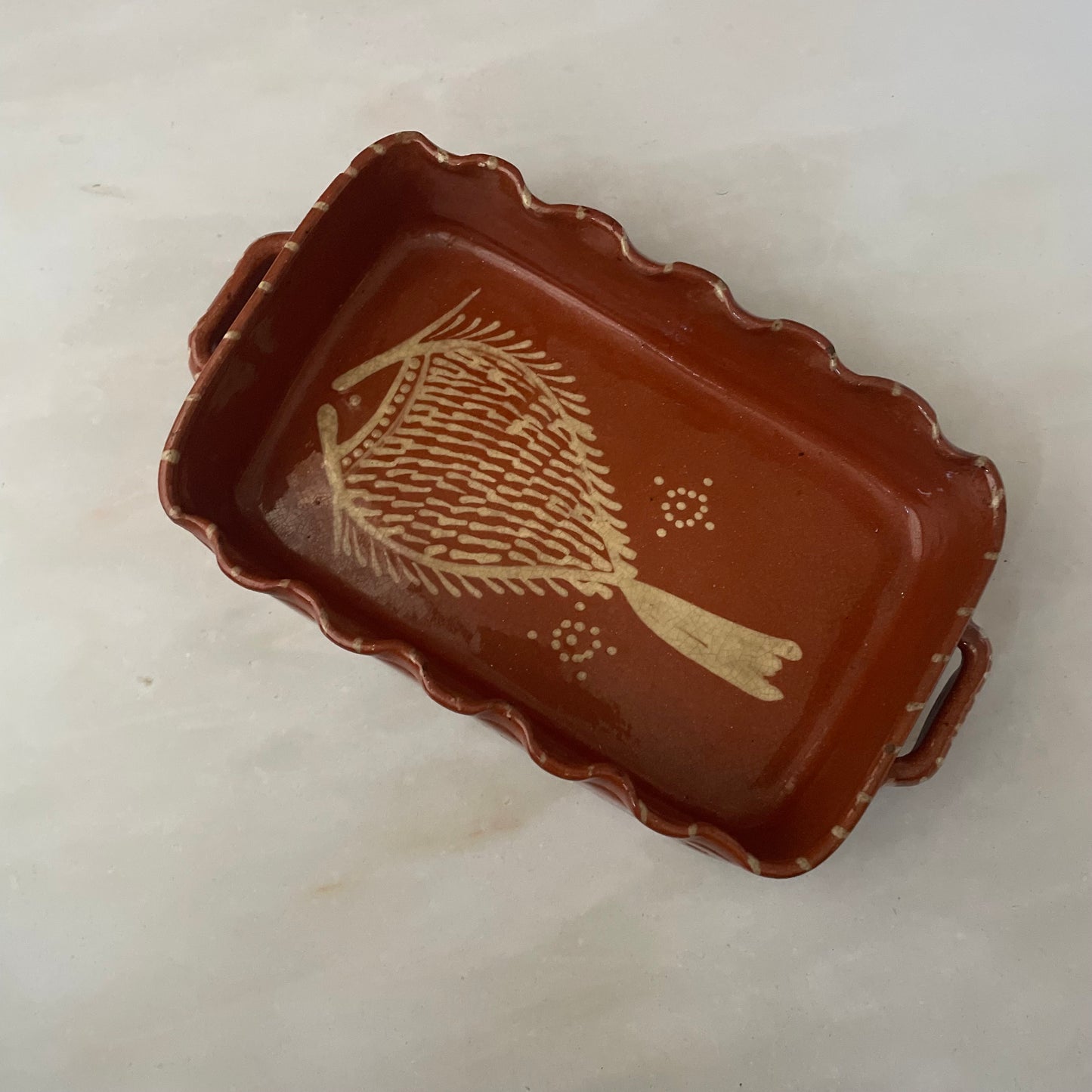 Terracotta dish with fish design