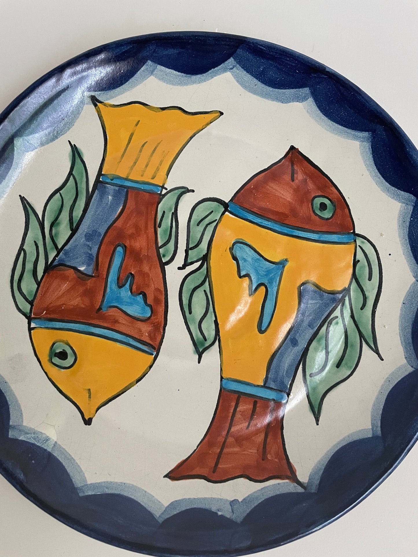 Vintage hand painted Mexican wall plate of colourful fish