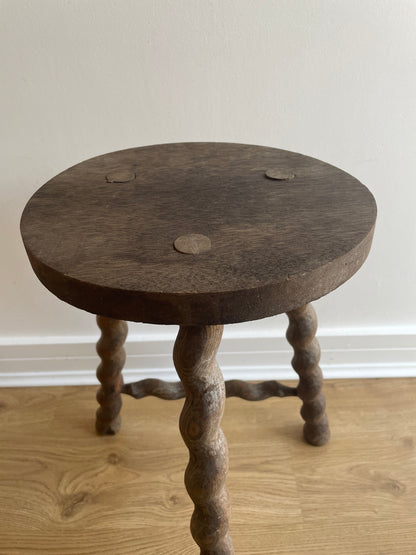 Antique French stool with wavy legs and round top