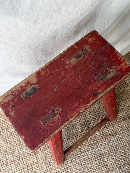 Vintage rustic red chipped wooden stool