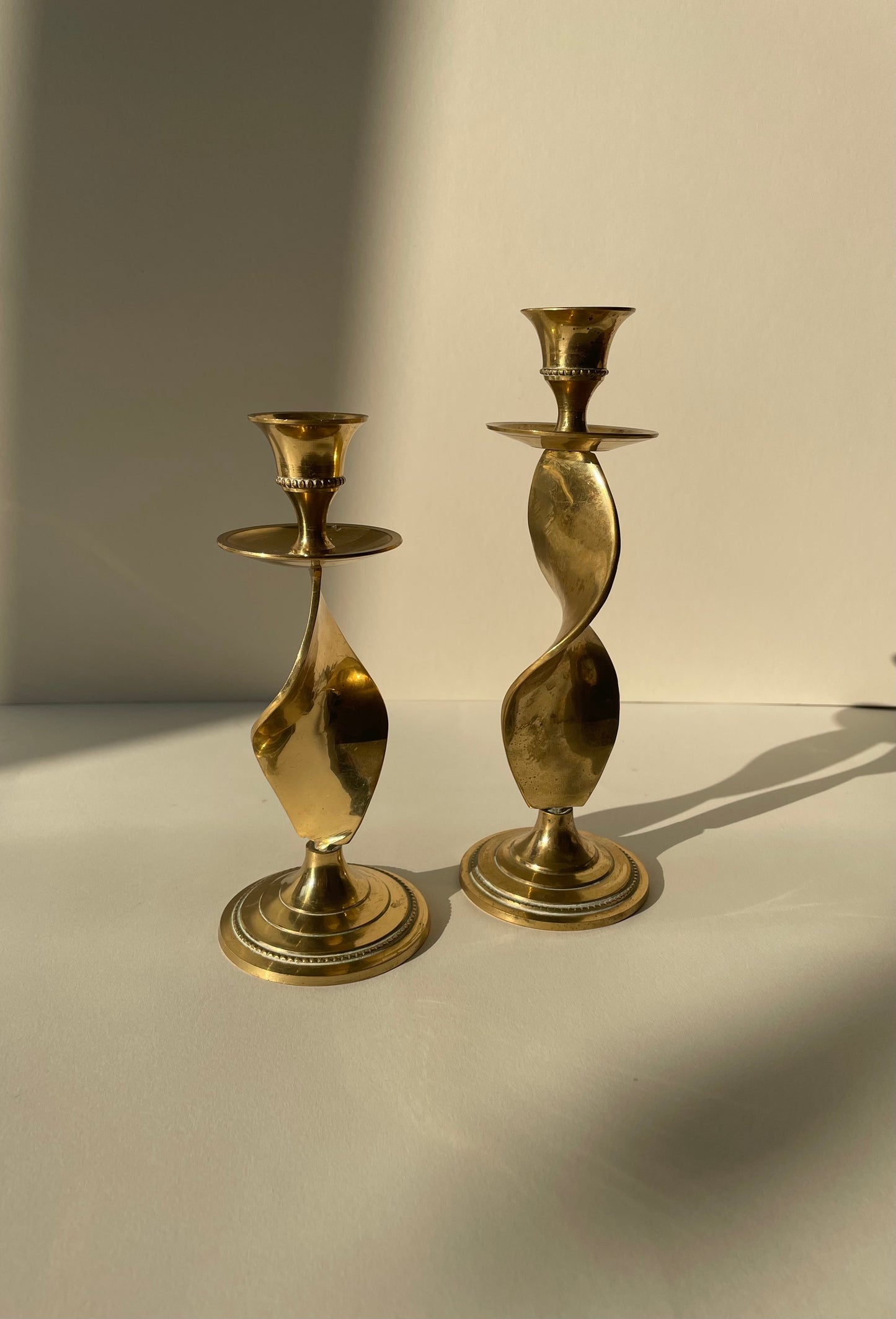 Vintage pair of brass twisted candle stick holders with drip tray