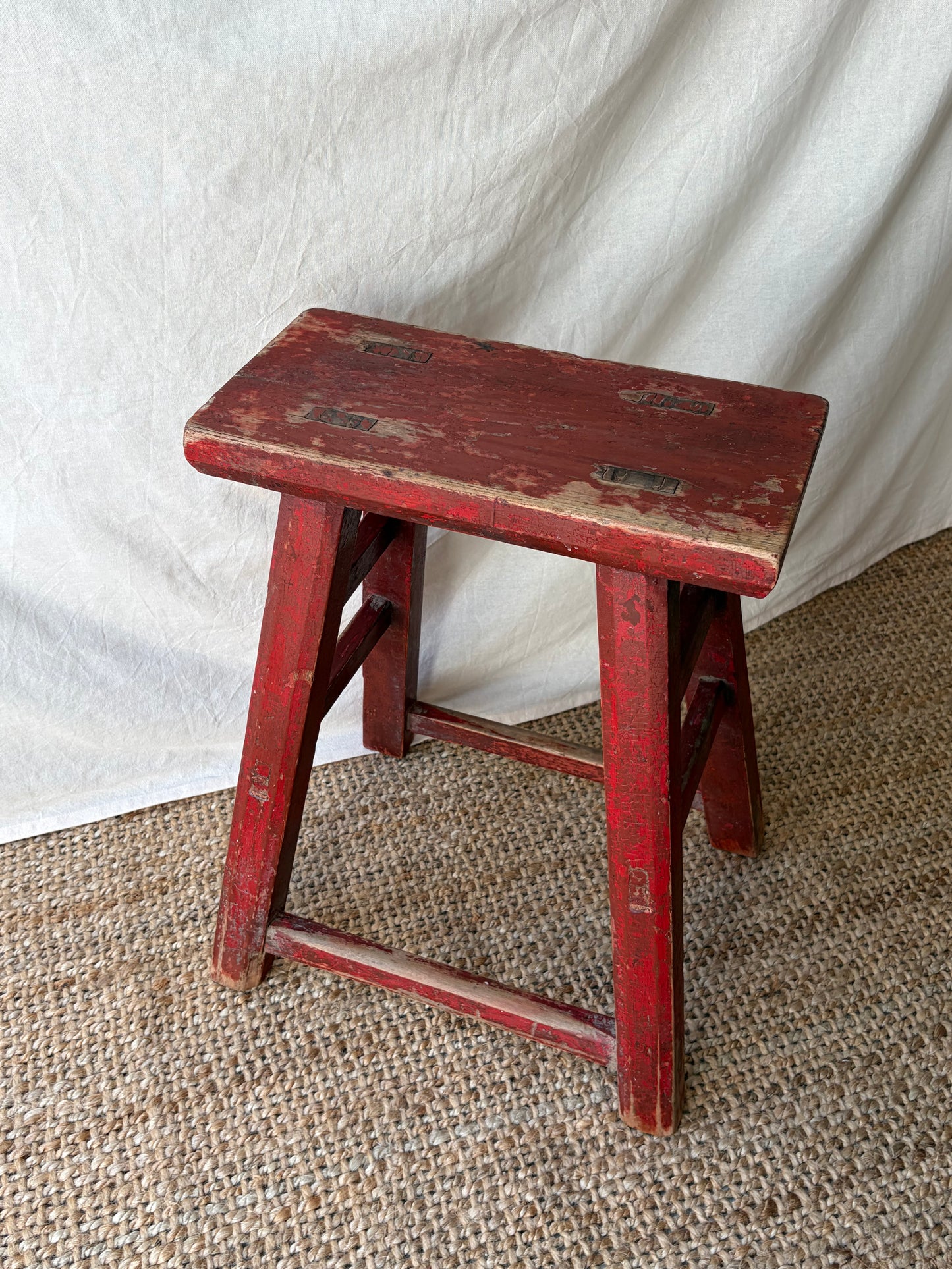 Vintage rustic red chipped wooden stool