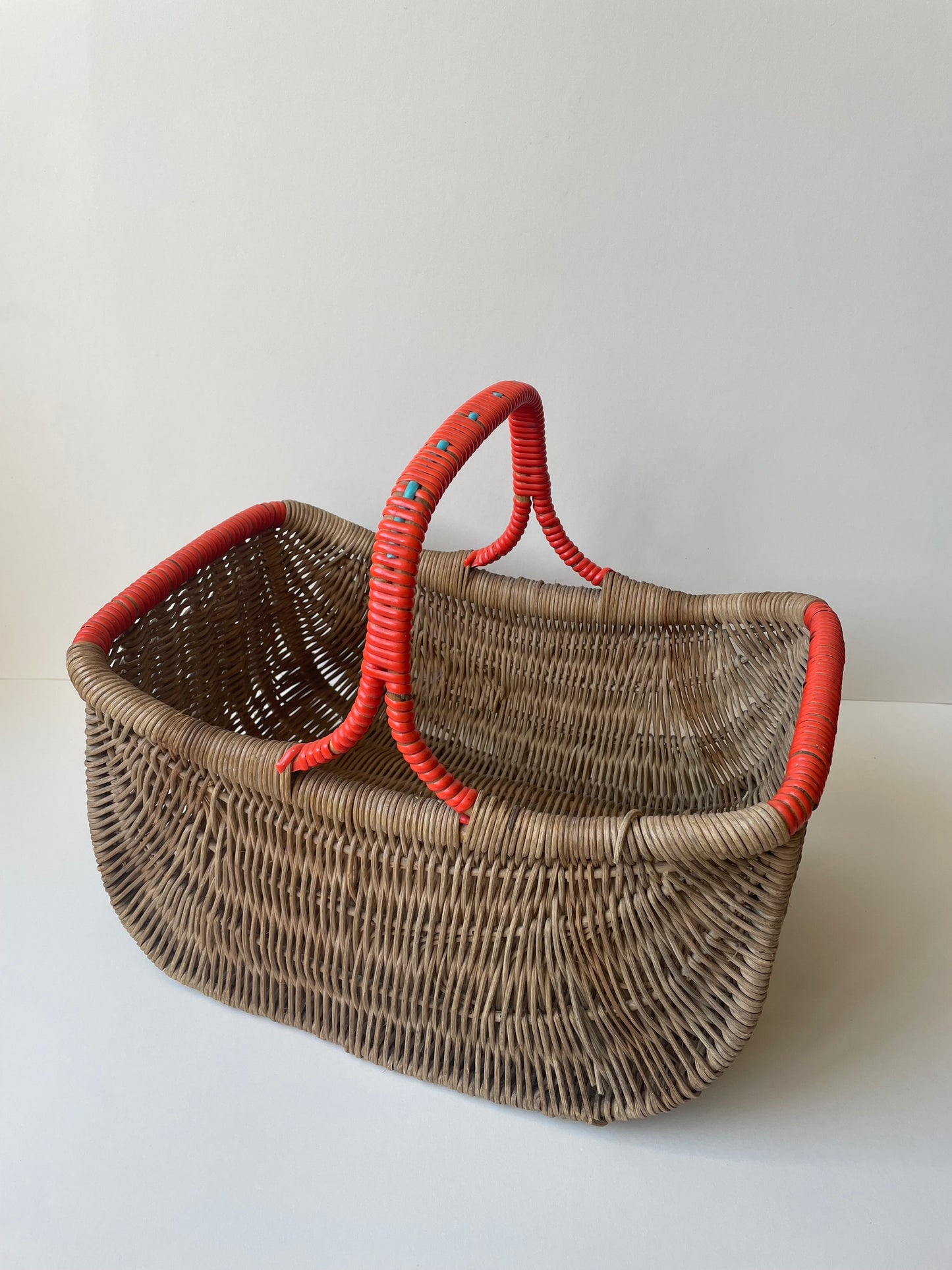 Wicker basket with red contrast handle