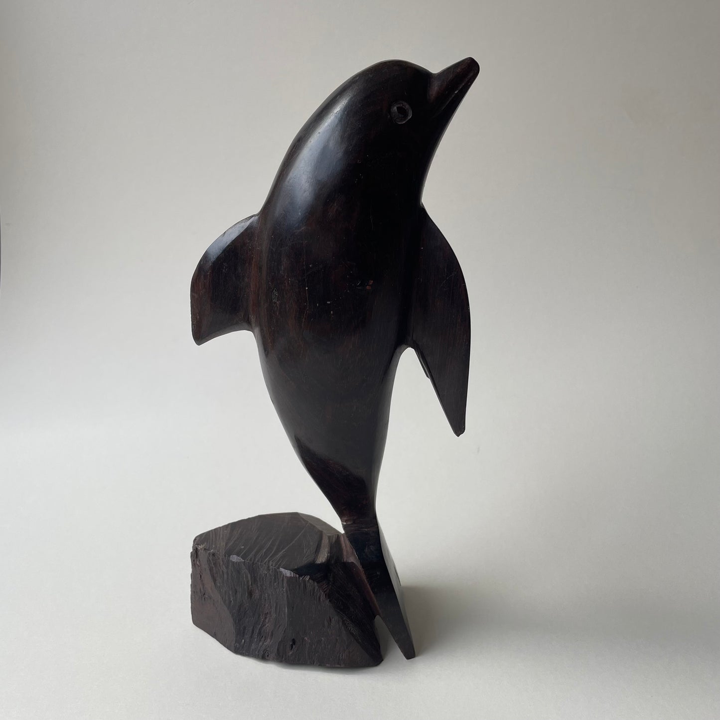 Large wooden dolphin statue