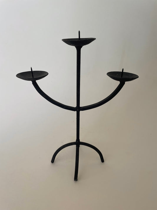 Black wrought iron three pronged candlestick holder
