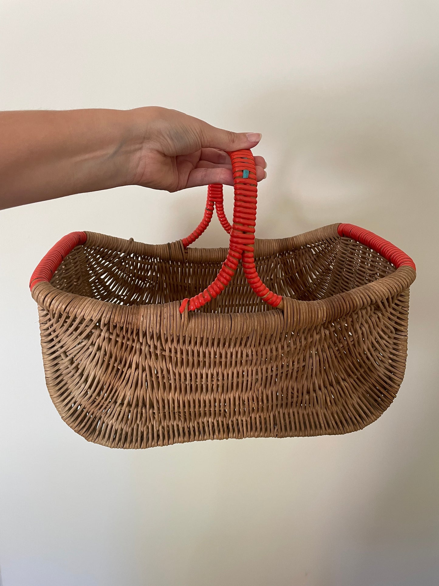 Wicker basket with red contrast handle