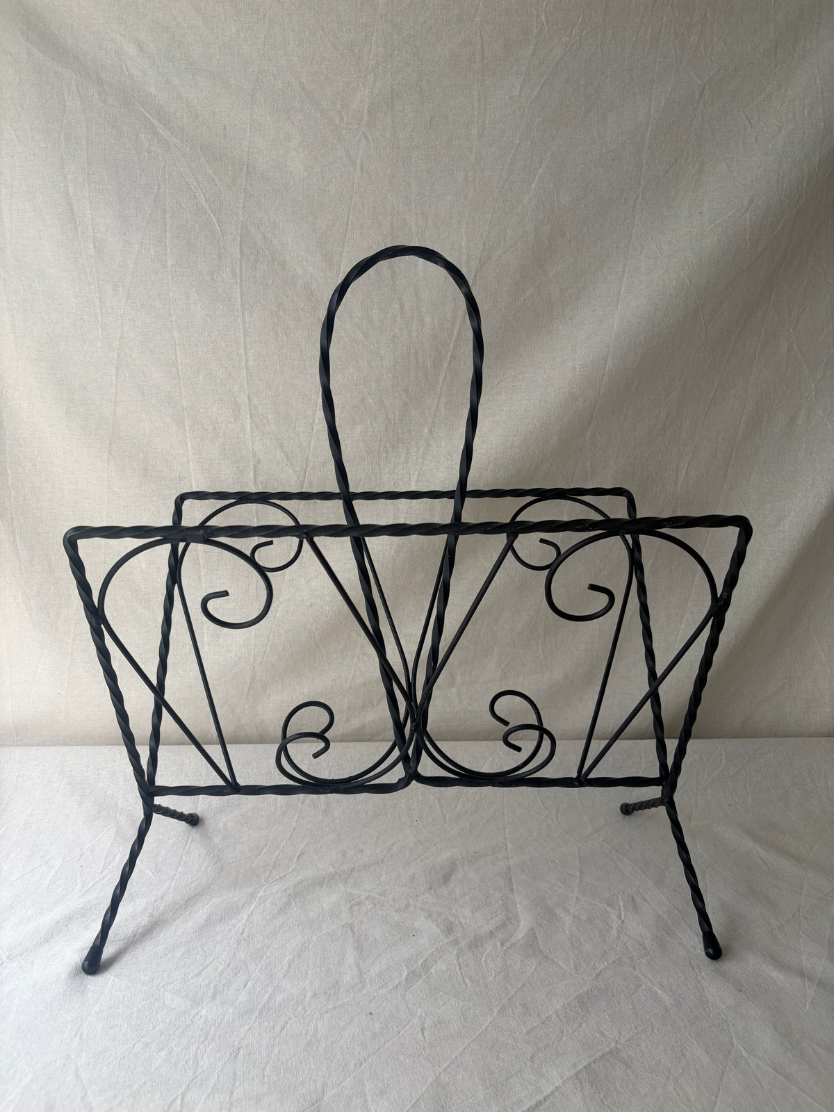 Vintage iron magazine rack with twisted and scroll details
