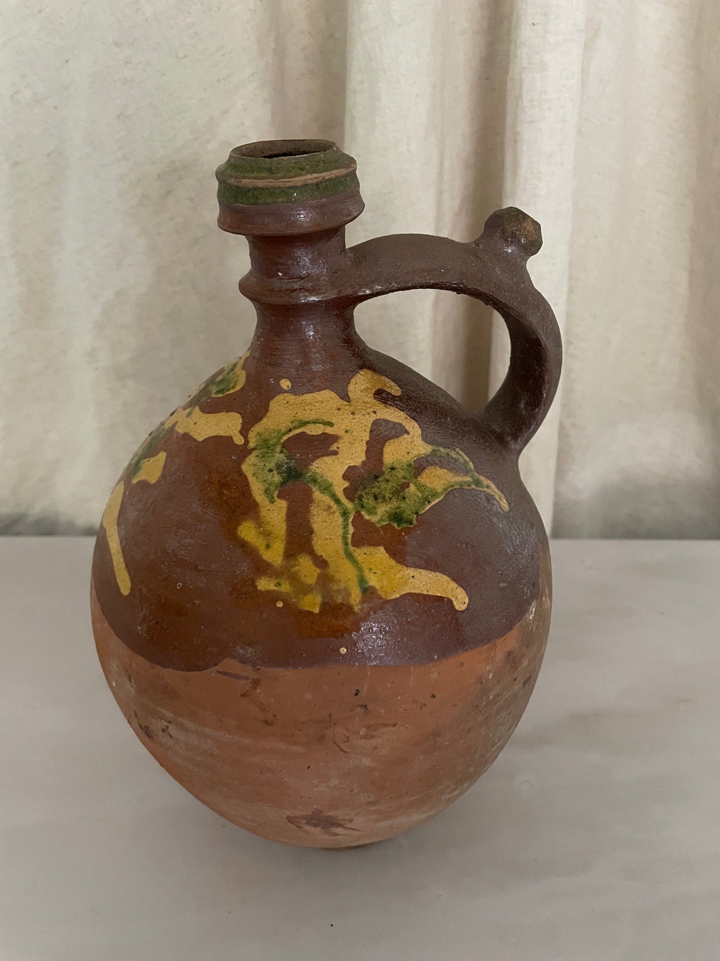 Terracotta jug with yellow