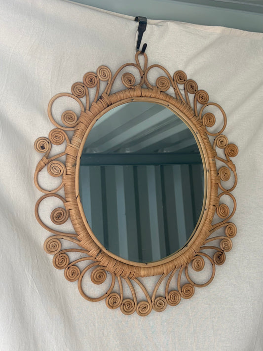 Vintage oval rattan mirror with scrollwork swirls
