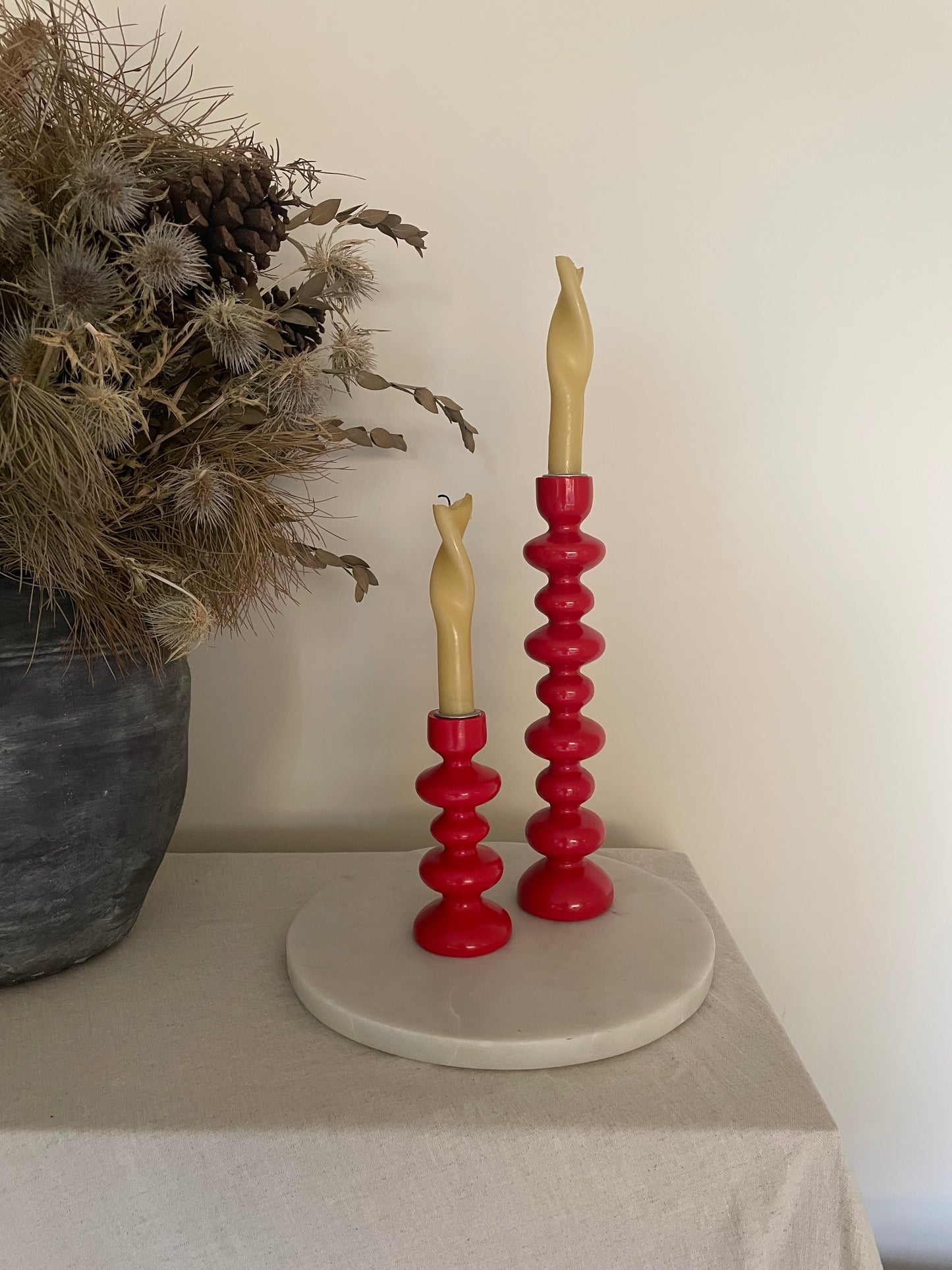 Vintage pair of red wooden bobbin candlestick holders