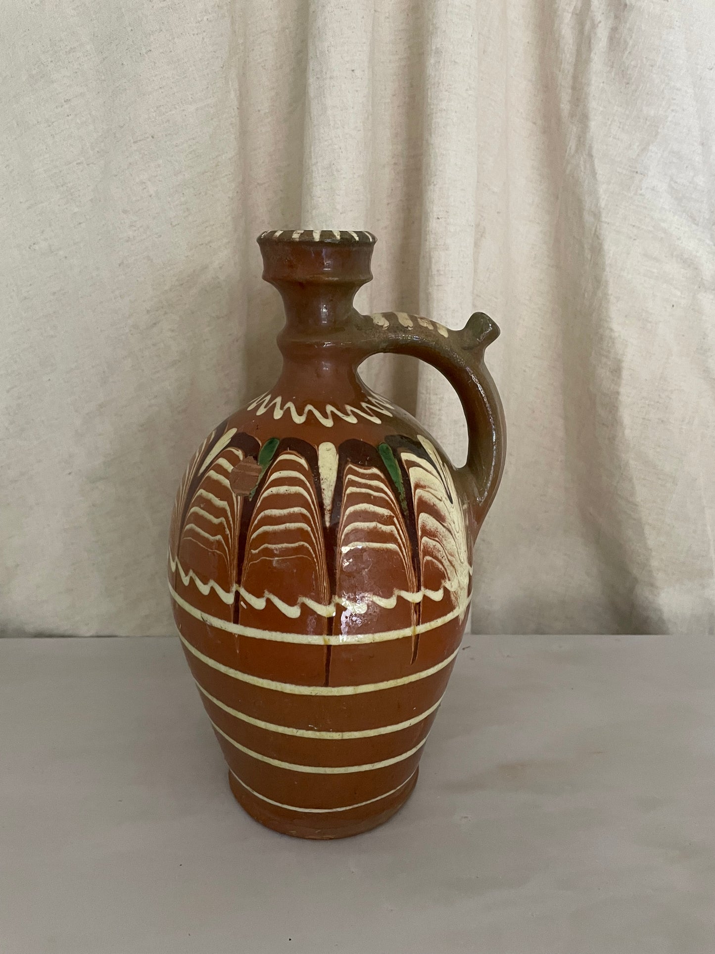 Terracota jug with white lines