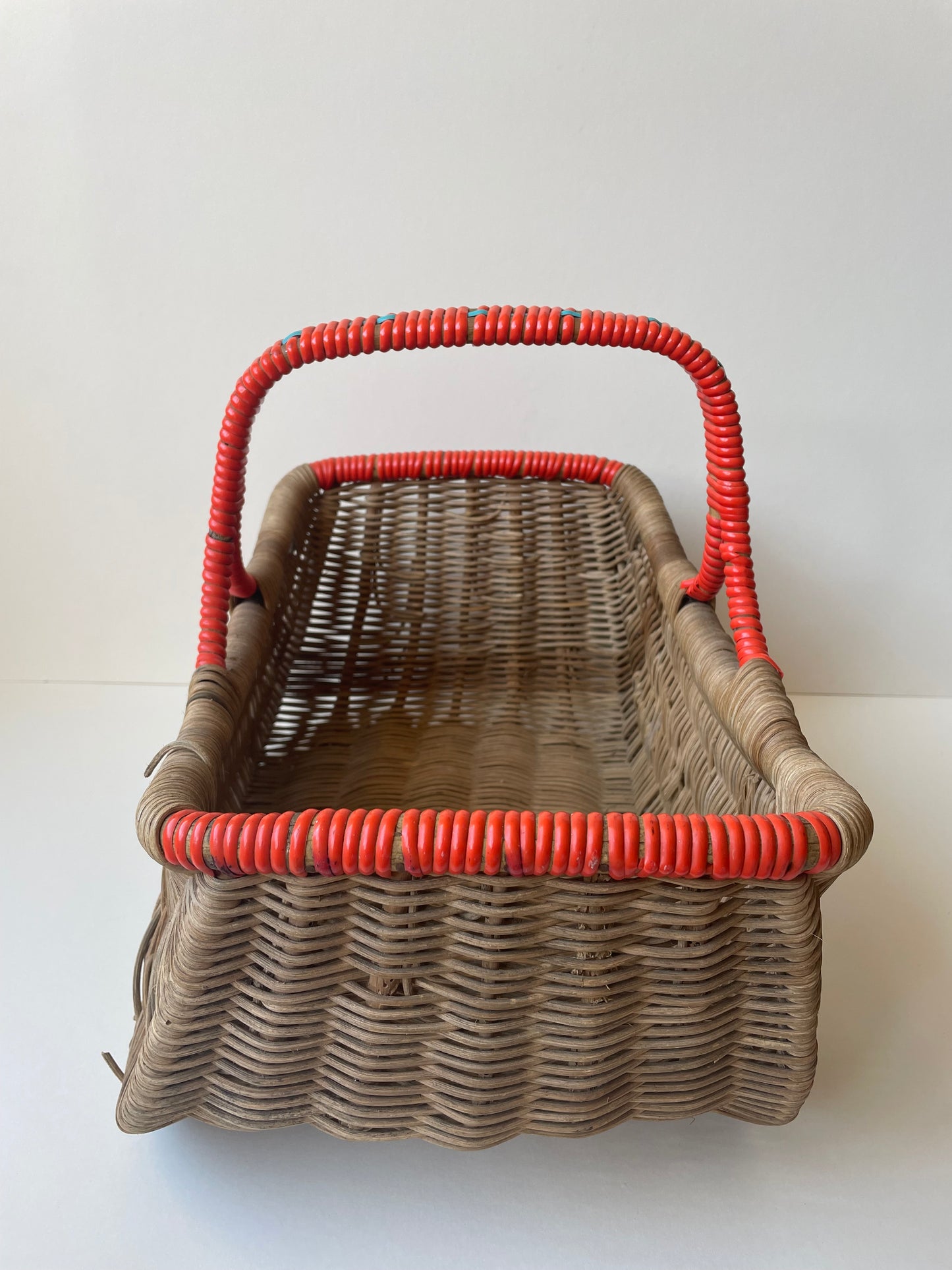 Wicker basket with red contrast handle