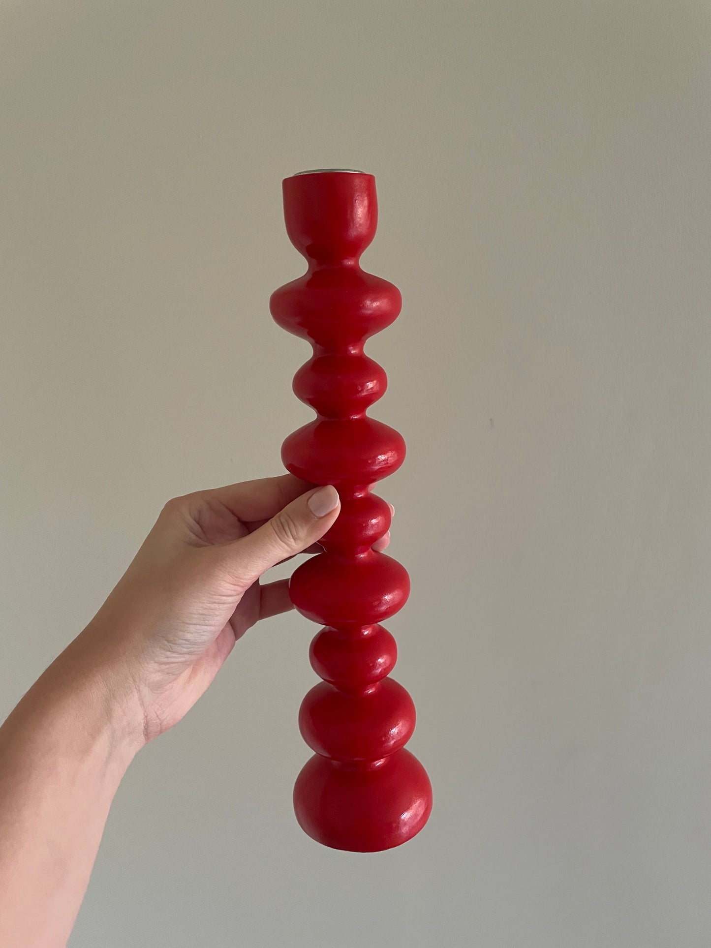 Vintage pair of red wooden bobbin candlestick holders