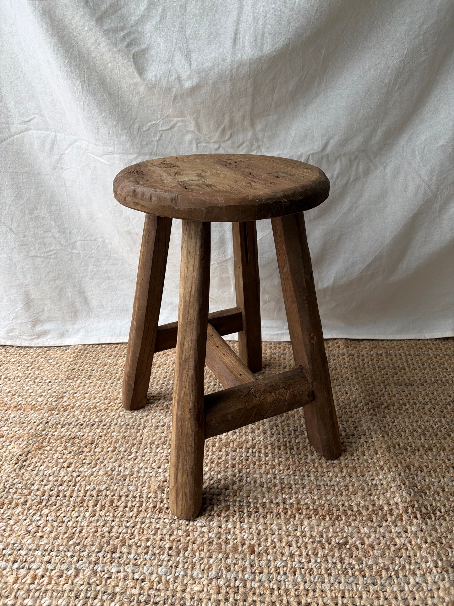 Vintage mid brown four legged wooden stool with round top