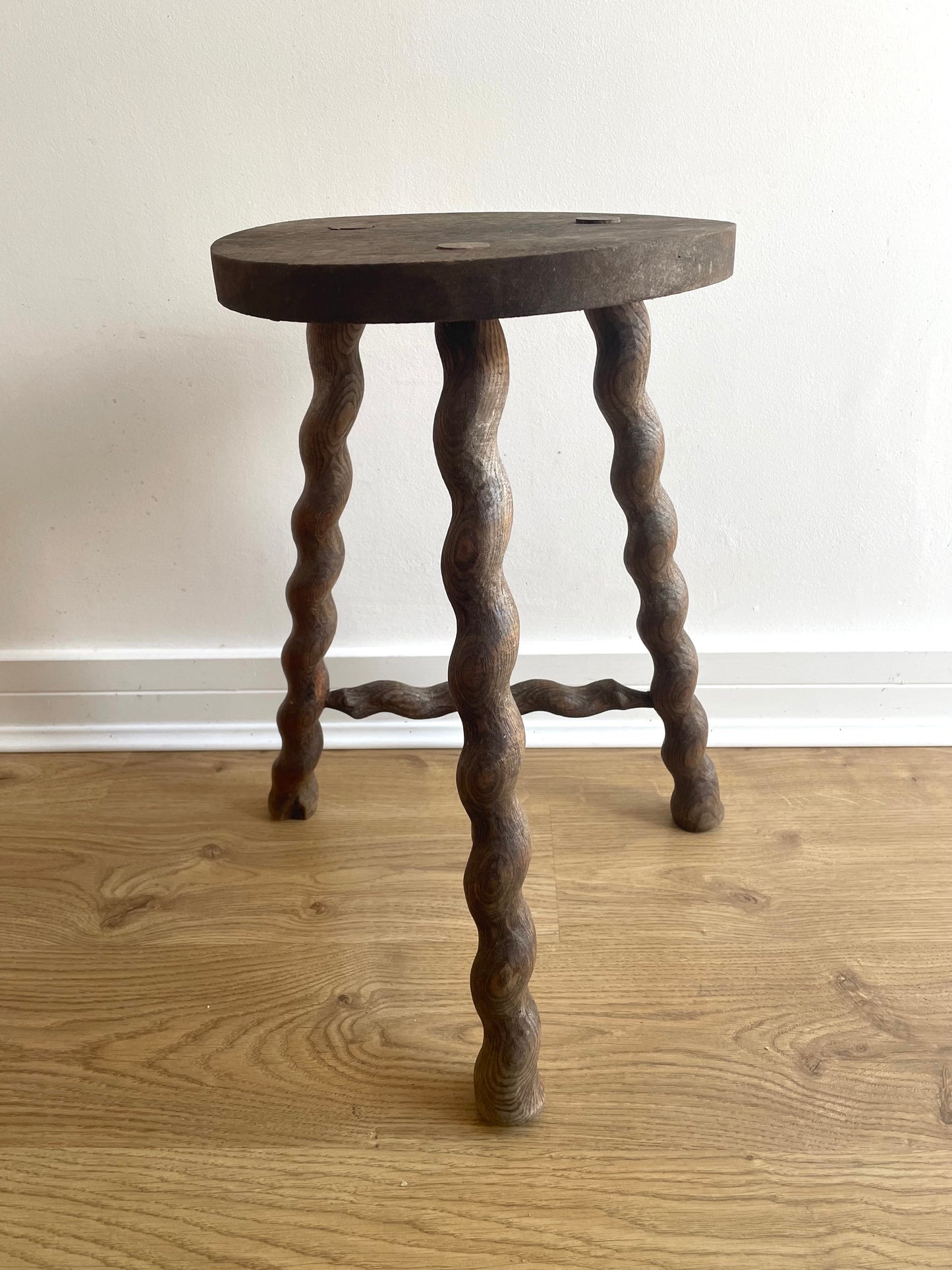 Antique French stool with wavy legs and round top