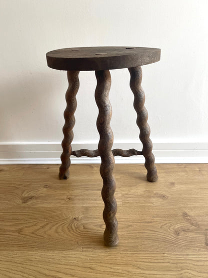 Antique French stool with wavy legs and round top