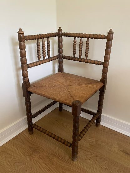 Antique turned oak corner chair with rush seat