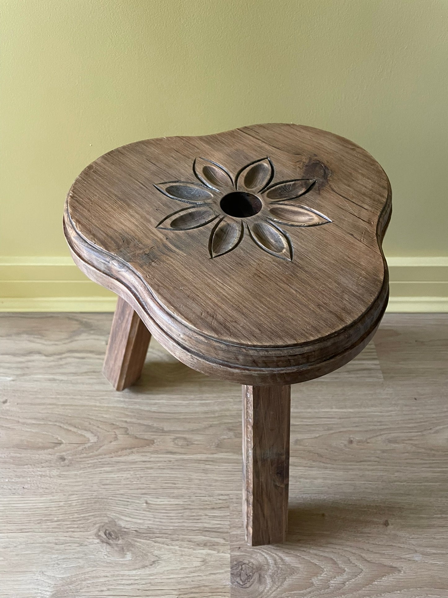Vintage French wooden milking stool with carved flower